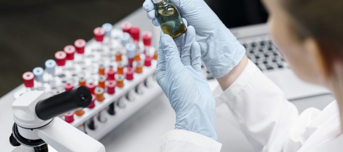 female-researcher-laboratory-with-test-tubes-vaccine-bottle