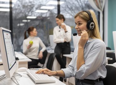 woman-working-call-center-talking-with-clients-using-headphones-microphone (1)